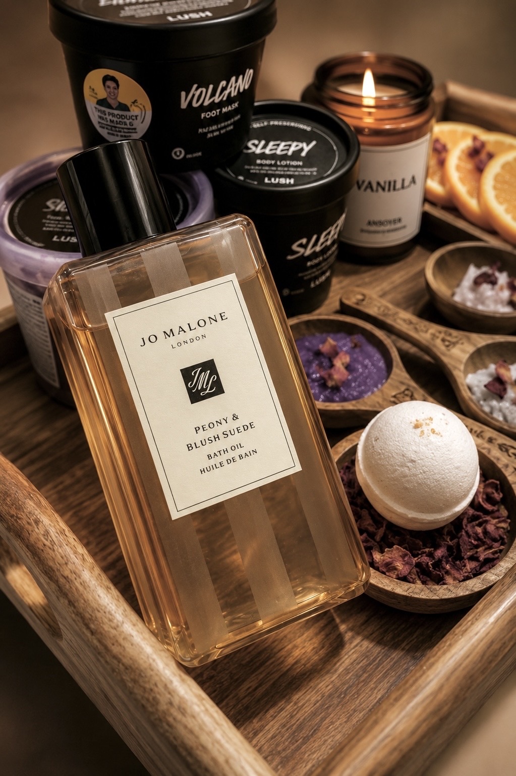 Luxury pedicure tray with Jo Malone Peony & Blush Suede bath oil, Lush Volcano foot mask, and a vanilla candle